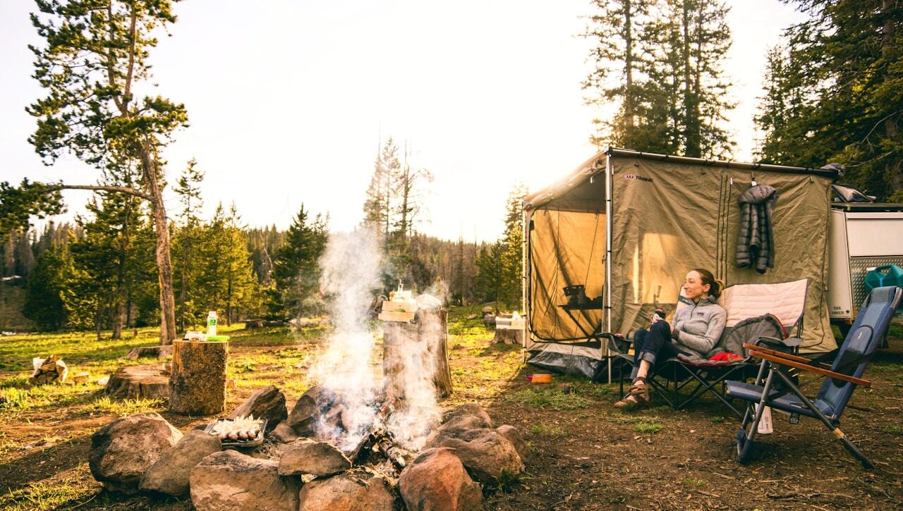woman sitting on chair near tent