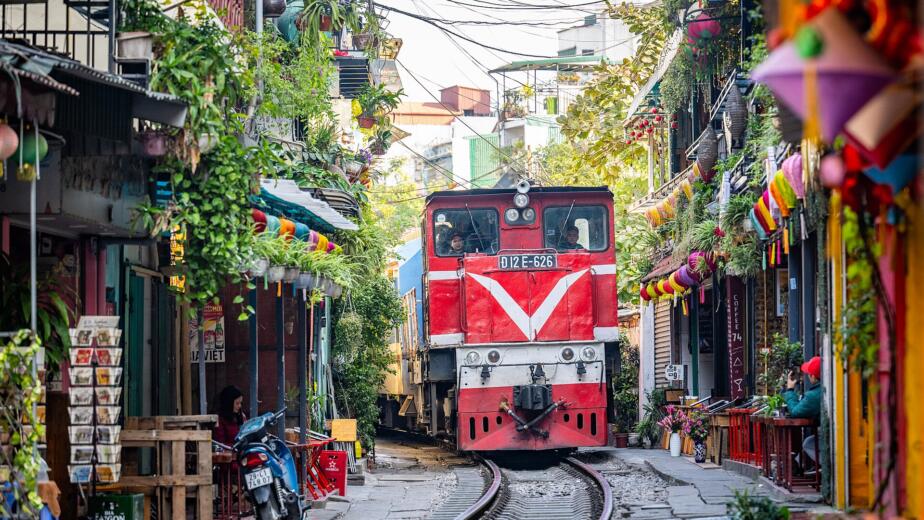 The Vietnamese street where trains pass inches from coffee shops twice a day — and the closures the government keeps trying to enforce