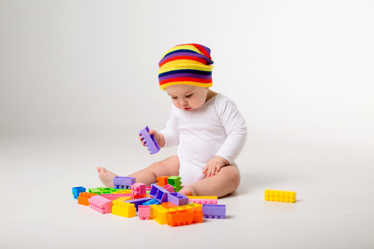 Baby playing blocks floor