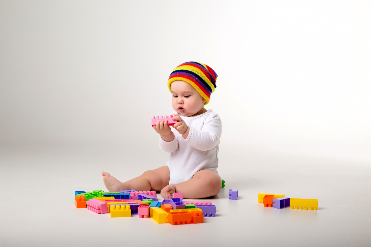Baby playing blocks floor