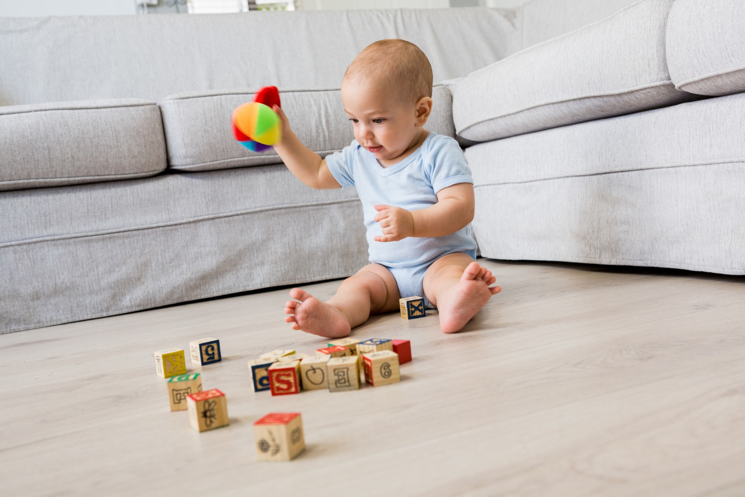 Baby playing blocks floor