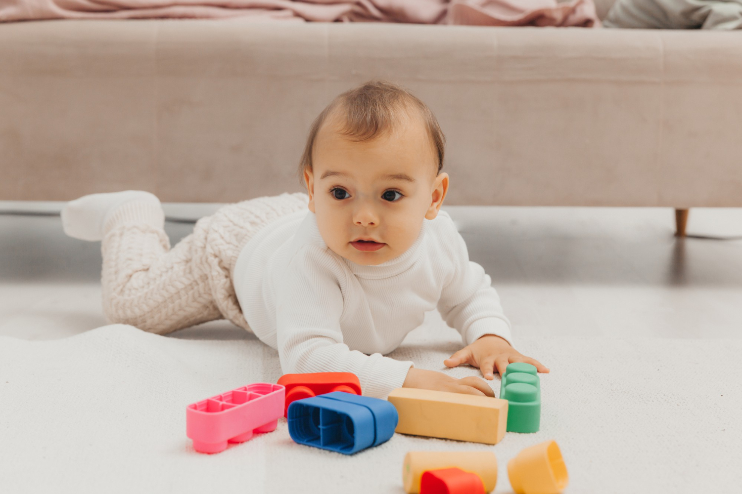 Baby playing blocks floor