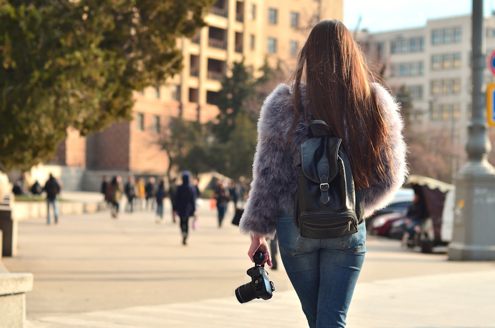 person photographing street