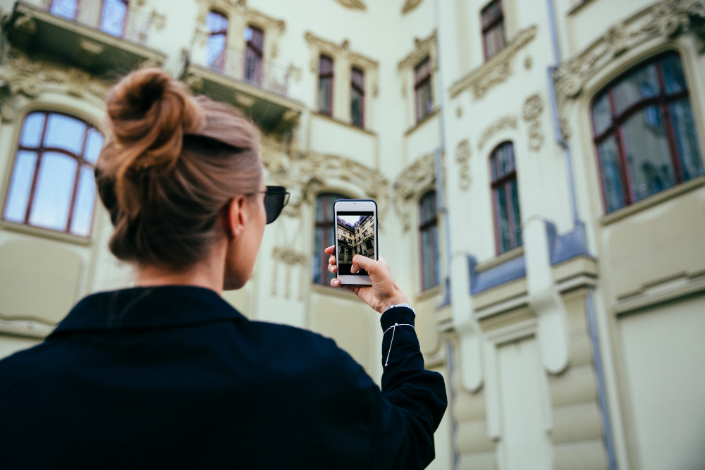 person photographing street